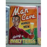 A large painted metal advertising sign Man Cave