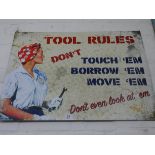 A large painted metal advertising sign 'Tool Rules'