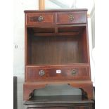 A small reproduction mahogany cabinet fitted one long and two short drawers