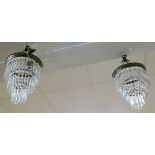 A pair of hanging glass electric light pendants