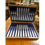 A set of twelve mother of pearl handled cake knives and forks in oak case