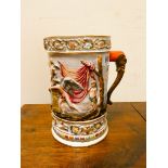 A Capo di Monte figure decorated mug with elephant trunk handle