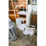 A metal and wood spiral staircase shaped plant stand