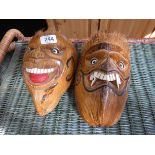 A pair of carved coconut masks