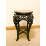A circular carved hardwood Chinese plant pedestal with inset marble top 15" diameter