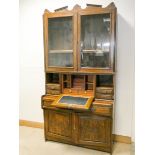 Edwardian oak glazed display cabinet with fitted a fitted bureau centre standing on a drawer and