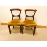 A set of five Victorian mahogany balloon back dining room chairs with gold upholstered seats