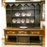 An antique Welsh style dresser with shelf and cupboard back,