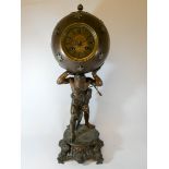A French Atlas bronze effect figure wall clock with ball shaped case and striking movement