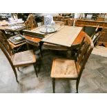 A 1920's mahogany extending dining table standing on reeded legs with two extra leaves,