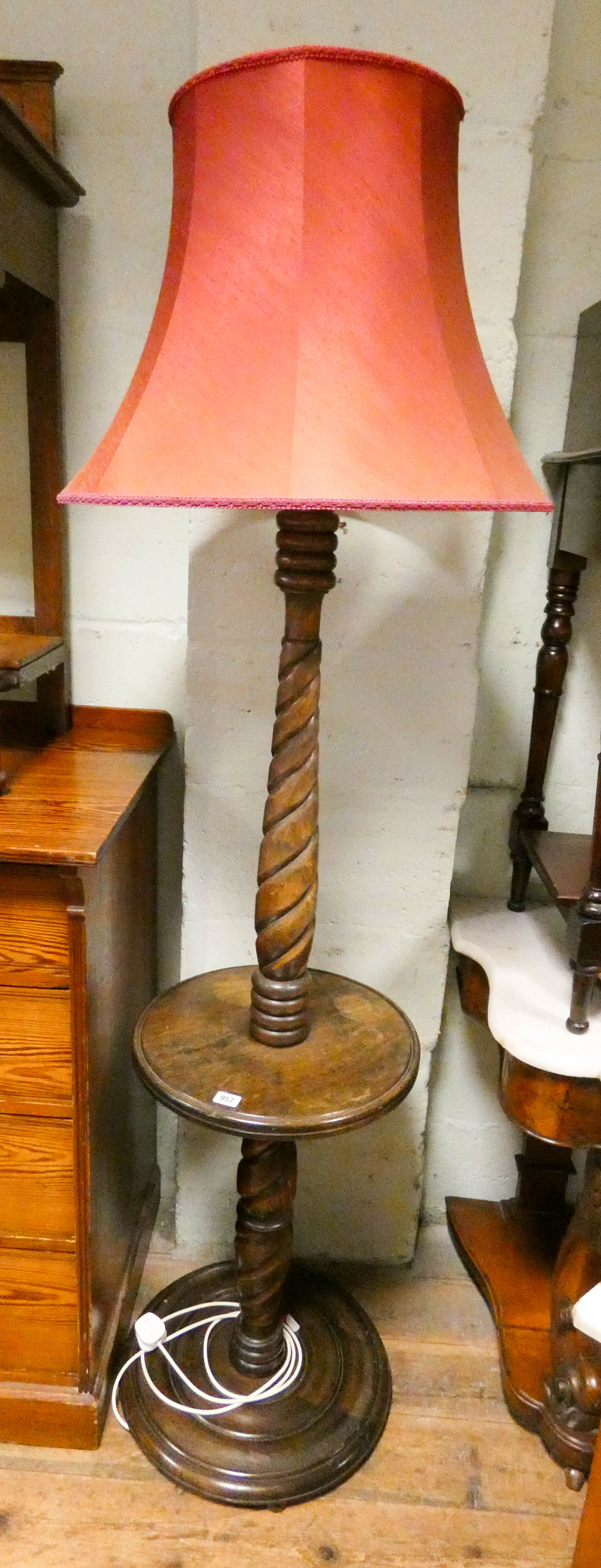 An oak barley twist standard lamp fitted centre table with red shade