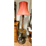 An oak barley twist standard lamp fitted centre table with red shade