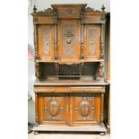 A French carved oak buffet with three door cupboard top, two large panel doors under,