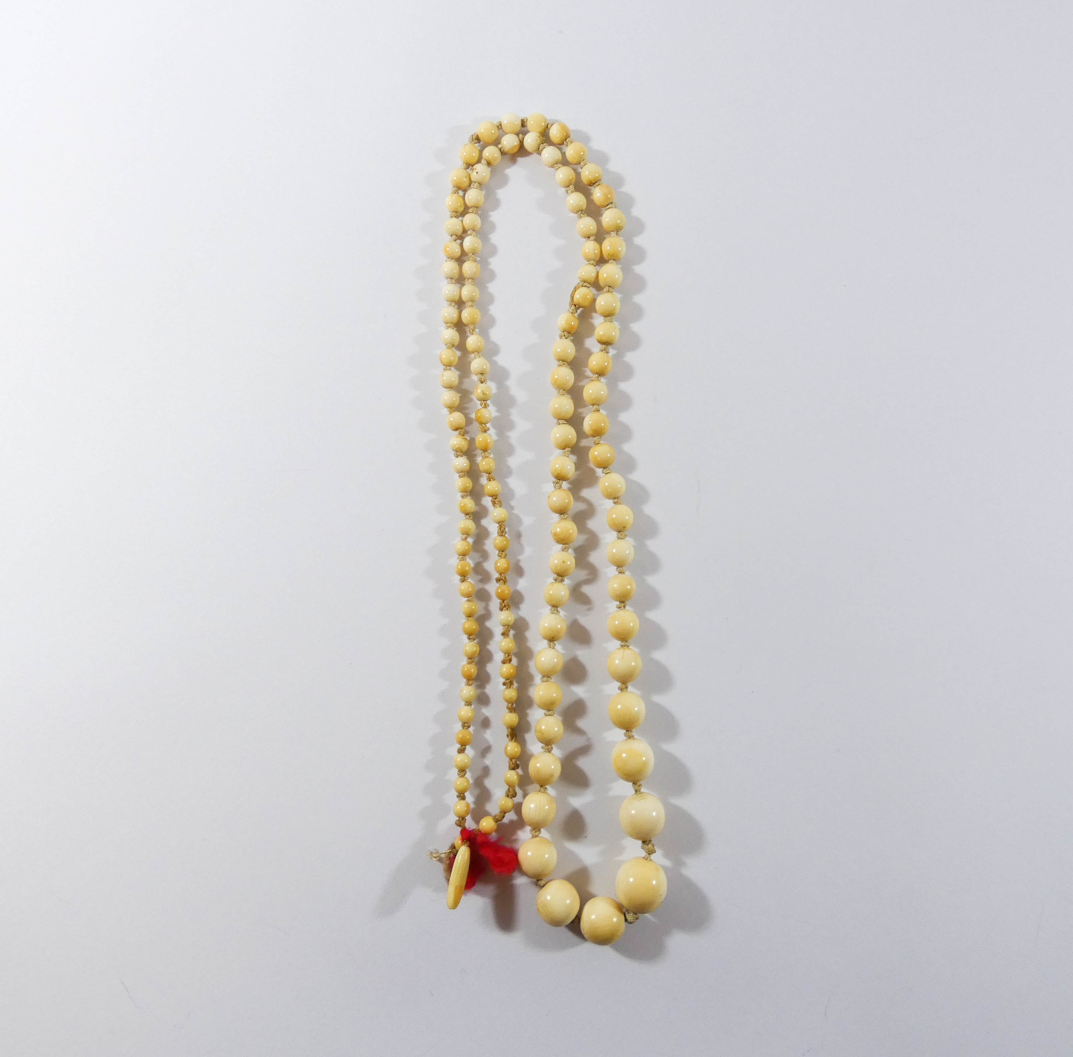 two rows of 1920's ivory beads and two rose carved Victorian pendants. - Image 2 of 5