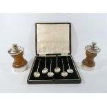 A set of silver hallmarked coffee spoons in their box together with two silver mounted pepper mills