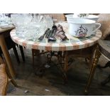 A circular marble effect garden table on metal base together with three cane elbow chairs