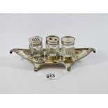A three piece silver cruet set standing on boat shaped stand, approx 20cms long,