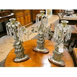 A three division brass figure decorated and lustre candelabra together with a pair matching
