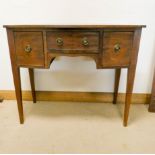 A Georgian style bow front mahogany side board fitted with drawer and cupboards on square taper