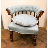 A late Victorian mahogany framed tub shaped elbow chair upholstered in pale blue material with