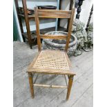 A pair of Edwardian bedroom chairs with cane seats