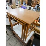 A nest of three 1970's teak coffee tables