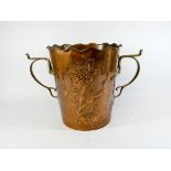 A Newlyn floral embossed copper champagne bucket with brass handles stamped on the base ODE with