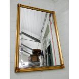 A large bevelled wall mirror in gilt frame