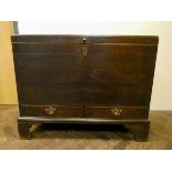 An antique oak mule chest with two drawers under standing on bracket feet,