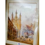 A pair of gilt framed watercolours of French street scenes with cathedrals in the background one is