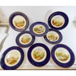 A Victorian dessert service decorated with topographical views of England within royal blue and