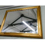 A very large bevelled wall mirror in a gilt frame