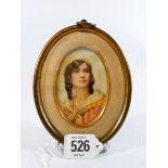 A 19th century gilt framed miniature painting on ivory depicting a female with dark hair wearing a