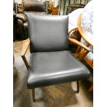 A wood arm fireside chair with black upholstered seat and back