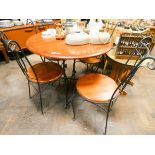 A circular black metal framed mahogany breakfast or patio table together with four matching chairs