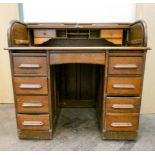 An oak roll top pedestal desk,