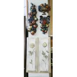 A pair of floral decorated plaques and three wall hanging fruit cluster ornaments