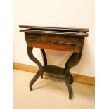 A mahogany folding top card table fitted drawer with a shelf under on four shaped legs 22" wide