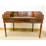 A mahogany Carlton House style writing desk fitted with the small back drawers and cupboards,