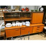 A 1960's/70's teak lounge sideboard unit with glass sliding doors,
