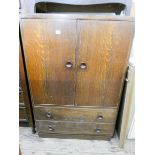 A 1950's oak tallboy fitted cupboards and two drawers 3' wide