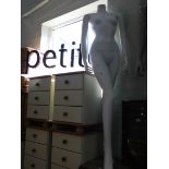 A life sized female shop dummy and a petit shop sign