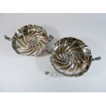 A pair of silver sweetmeat or bon bon dishes with two decorative handles and decorated with a