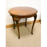 An early 19th century circular mahogany occasional table on cabriole style legs with rope edged top