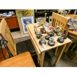 A modern light oak drop leaf kitchen table and a pair of similar slat back chairs with brown