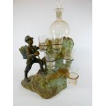 A Victorian decanter stand modeled as an Alpine Climber complete with decanter and five shot