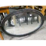 A large oval wall mirror iron frame