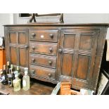 An Ercol dark oak dining room suite comprising refectory style table,