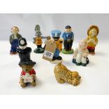 A collection of nine Wade figures to include a policeman, a dog,