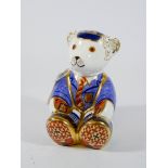 A Royal Crown Derby paperweight and a school boy Teddy